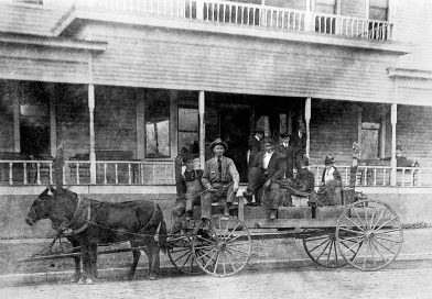 Ewell McClinton and Chancellor Edwards in wagon in front of the Pleasant Hotel